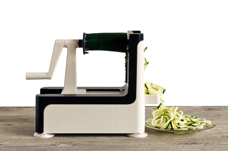 Lateral view of vegetable spiralizer making raw zucchini noodles (zoodles) .の写真素材