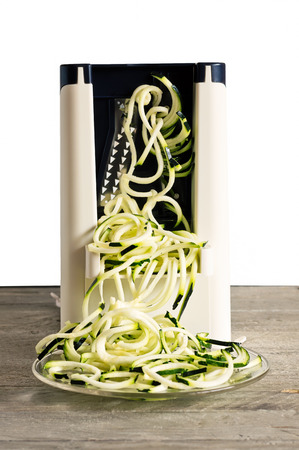 Front view of vegetable spiralizer making raw zucchini noodles (zoodles) .の写真素材