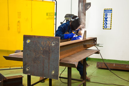 Man welding a beam