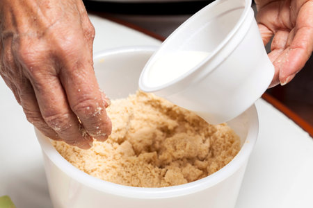 Adding milk to dough
