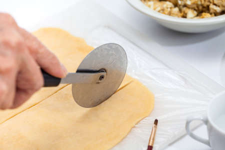 Ravioli Preparation : Cutting pasta dough into stripsの写真素材