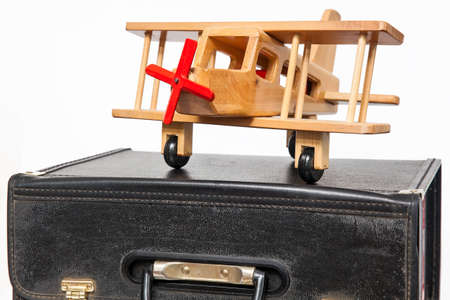 Travel concept : retro style suitcase and biplane on white backgroundの写真素材