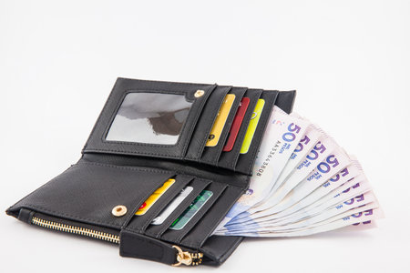 Black wallet filled with money and cardsのeditorial素材