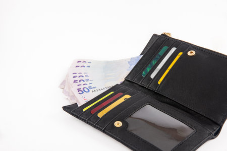 Black wallet filled with money and cardsのeditorial素材