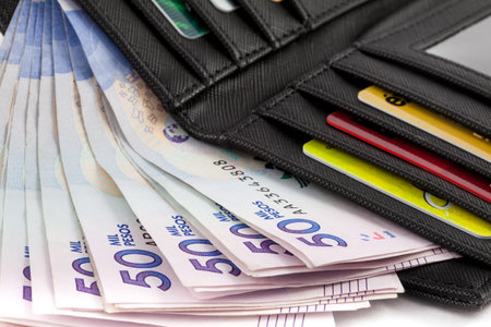 Black wallet filled with money and cardsのeditorial素材