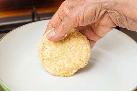 Traditional Colombian Arepa de Choclo Preparation: Cooking the corn bread on a panの写真素材