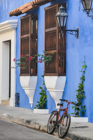 Red bicycle parked at the walled city in Cartagena de Indiasの写真素材