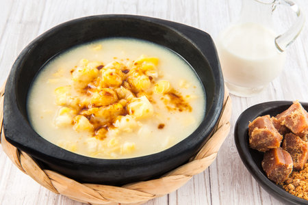 Traditional Colombian corn mazamorra served in black ceramic dishの写真素材