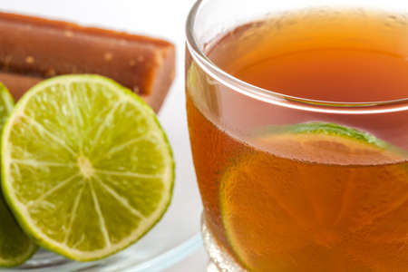 Cold sugarcane-water (aguapanela) with lemonの写真素材