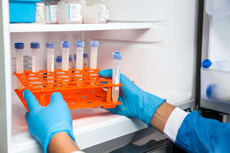 Young male scientist and laboratory freezerの写真素材