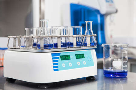 Laboratory shaker loaded with erlenmeyers and beakersの写真素材