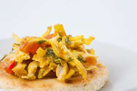 Traditional Colombian arepa topped with chicken breastの写真素材