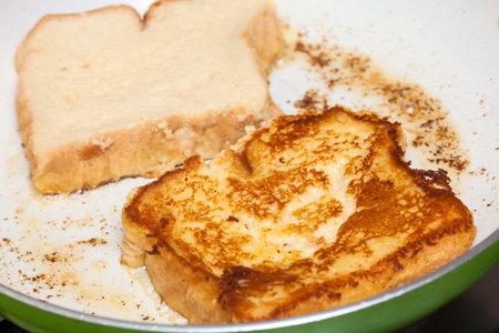 French toast preparation: Cooking french toasts on a pan