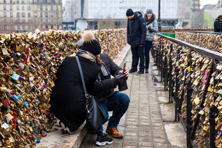 Couple taking a selfie at the Pont Neuf love locks in Paris