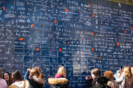 Tourists at the I Love You Wall located at the famous Parisian Montmartre neighborhood in winterのeditorial素材