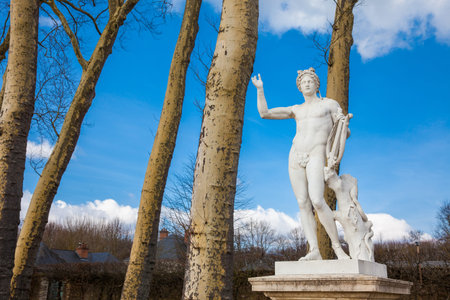 Statue of Apollo with a lyre in the garden of the Versailles Palace in a freezing winter day just...