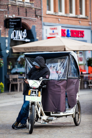Bike taxi at Dam Square in the Old Central district of Amsterdam