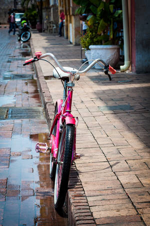 Bicycle parked at the beautiful streets of the walled city in Cartagena de Indiasの写真素材