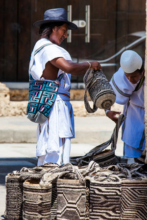 Two Arhuaco men dressed with their traditional clothes selling traditional bags in Cartagena de Indiasのeditorial素材