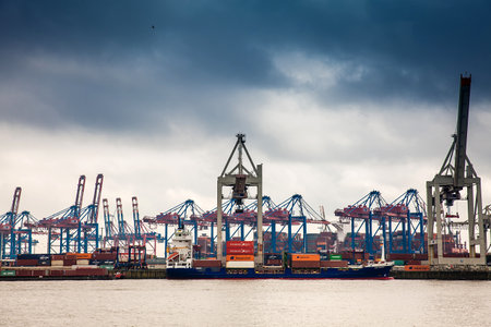 Industrial port cargo logistics containers and ship cranes in Hamburgのeditorial素材