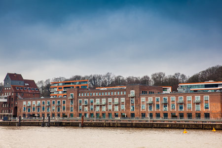 Buildings on the banks of the Elbe River on a cloudy end of winter dayのeditorial素材