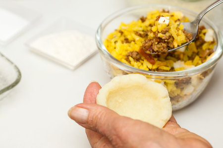 Preparation steps of traditional Colombian dish called stuffed potatoes : Stuffing the mashed...