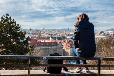 Young woman at the top of the Letna hill looking at the beautiful Prague cityのeditorial素材