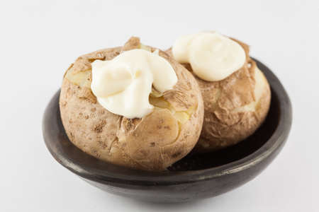 Traditional Colombian cooked potatoes called papas saladas topped with mayonnaise isolated on white backgroundの写真素材