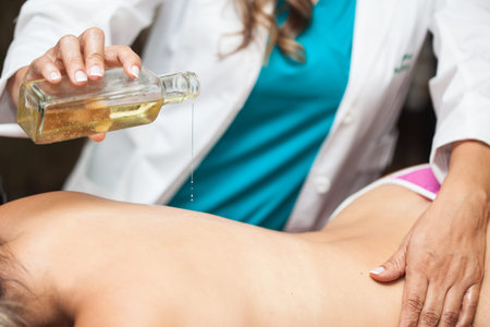 Doctor performing a relaxation massage on a young female patient