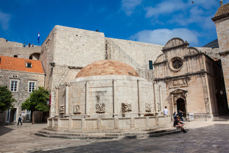 DUBROVNIK, CROATIA - APRIL, 2018: Tourists at the Large Onofrio Fountain located at Stradun street in the old town of Dubrovnikのeditorial素材