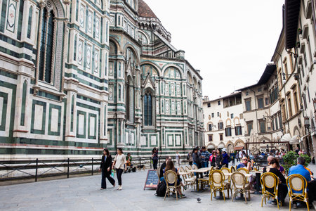Tourists at a restaurant next to the beautiful Florence Cathedral consecrated in 1436のeditorial素材