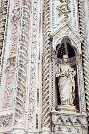 Statue on the facade of the beautiful Florence Cathedral formally called Cattedrale di Santa Maria del Fiore consecrated in 1436の写真素材