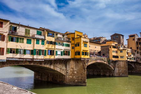 Tourists at Ponte Vecchio to medieval stone closed-spandrel segmental arch bridge over the Arno River in Florenceのeditorial素材