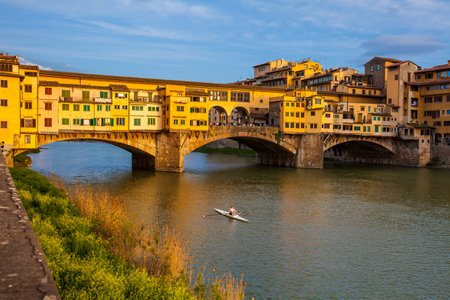 Golden hour at the Ponte Vecchio to medieval stone closed-spandrel segmental arch bridge over the Arno River in Florenceのeditorial素材