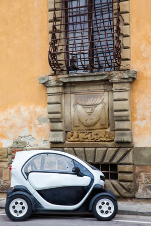 Electric car parked in the beautiful streets of Pisaのeditorial素材