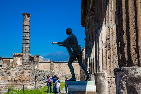 Ruins of the ancient Temple of Apollo with bronze Apollo statue in Pompeiiのeditorial素材