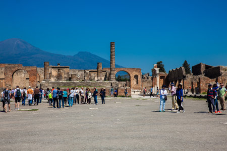 POMPEII, ITALY - APRIL, 2018: Tourists visiting the Temple of Jupiter at the Forum of the ancient city of Pompeii in a beautiful early spring dayのeditorial素材