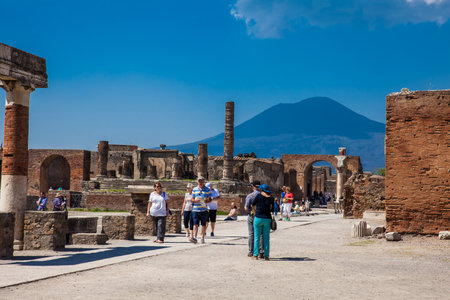 POMPEII, ITALY - APRIL, 2018: Tourists visiting the Temple of Jupiter at the Forum of the ancient city of Pompeii in a beautiful early spring dayのeditorial素材
