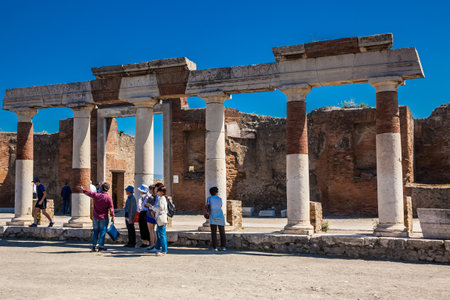Tourists visiting the ruins of the Forum at the ancient city of Pompeii in a beautiful early spring dayのeditorial素材