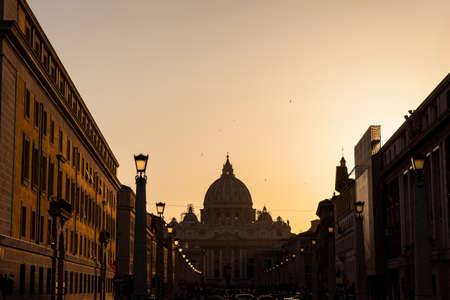 The sunset falls over the beautiful Constantinian Basilica of St. Peter at the Vatican Cityの写真素材