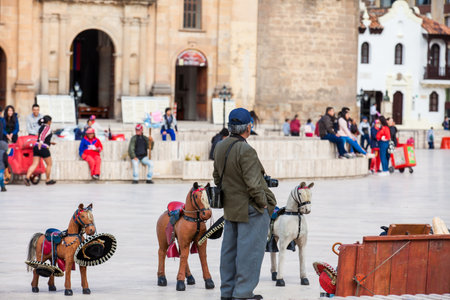 TUNJA, COLOMBIA - AUGUST, 2019:  Senior male traditional photographer at Bolivar Square in Tunja downtownのeditorial素材