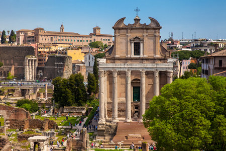 Tourists visiting the Roman Forum and the Temple of Antoninus and Faustina in Romeのeditorial素材