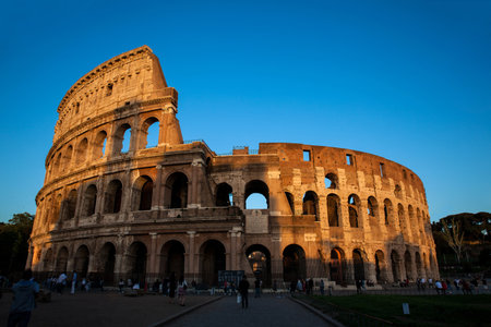 ROME, ITALY - APRIL, 2018: Tourists visiting the famous Colosseum under the beautiful light of the golden hour in Romeのeditorial素材