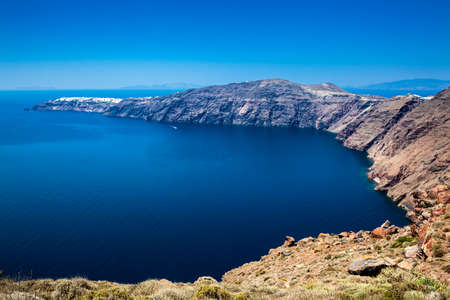 The beautiful Aegean Sea seen from the walking trail number 9 which connects the cities of Fira and Oia on the Santorini Islandの写真素材