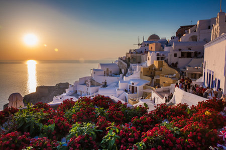 SANTORINI, GREECE - APRIL, 2018: Tourists looking at the amazingly beautiful sunset at La Caldera in Oia city in Santorini Islandのeditorial素材