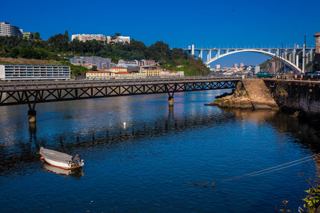 View of the Duoro River and the Cais das Pedras Viaduct in a beautiful early spring day at Porto...
