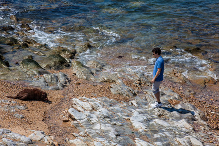 OPORTO, PORTUGAL - MAY, 2018:  Man playing with his dog in a sunny early spring day at the beautiful beaches along the Porto city coastのeditorial素材