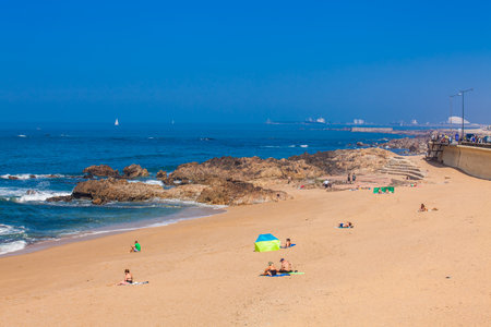 PORTO, PORTUGAL - MAY, 2018:  People enjoying a sunny early spring day at the beautiful beaches along the Porto city coastのeditorial素材