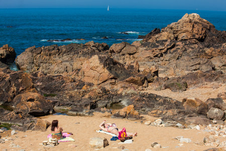 PORTO, PORTUGAL - MAY, 2018:  People enjoying a sunny early spring day at the beautiful beaches along the Porto city coastのeditorial素材