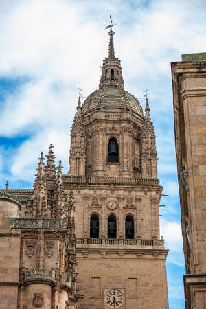 View of the bell tower of the historical Salamanca Cathedralの写真素材